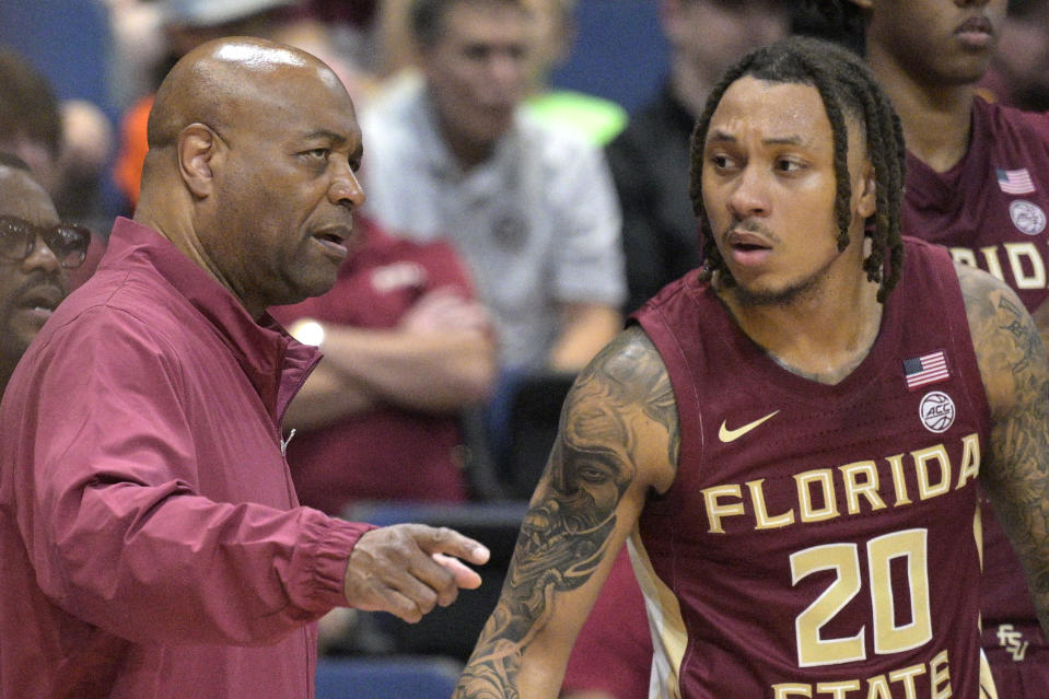 Florida State head coach Leonard Hamilton, left, gives instructions to guard Josh Nickelberry (20) during the first half of an NCAA college basketball game against Colorado, Tuesday, Nov. 21, 2023, in Daytona Beach, Fla. (AP Photo/Phelan M. Ebenhack)