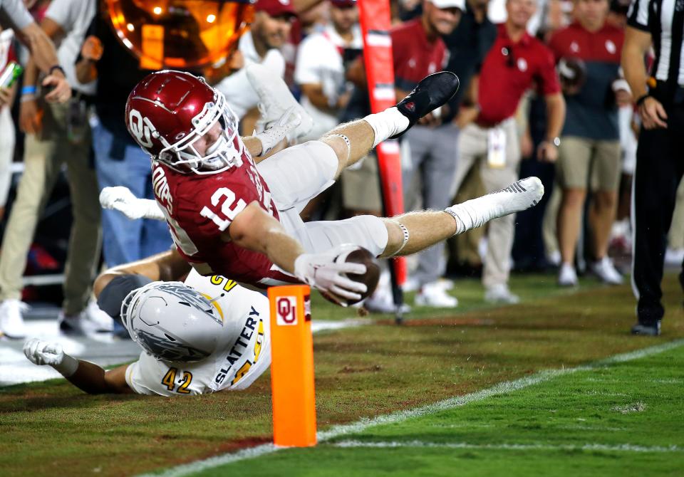 OU's Drake Stoops (12) dives for a touchdown over Kent State's Shane Slattery (42) in the third quarter of a 33-3 win on Sept. 10 in Norman.