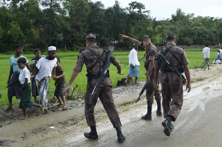 Bangladesh Border Guard (BGB) attempts to clear Rohingya Muslim refugees off a road near Balukhali refugee camp near the Bangladehsi district of Ukhia on September 19, 2017