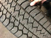 In this photo released Saturday, Aug. 8, 2020, by the Portland Police Department is a police vehicle tire that suffered damage from nail punctures, that authorities said was caused by a pool noodle filled with nails placed on a roadway to damage police vehicle tires during demonstrations in Portland, Ore. Violent protests have often roiled Oregon's largest city for more than two months since George Floyd was killed in Minneapolis. (Portland Police Department via AP)