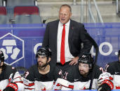 FILE - In this June 5, 2021, file photo, Canada head coach Gerard Gallant, top, stands behind his bench during the Ice Hockey World Championship semifinal match against the United States in Riga, Latvia. The New York Rangers have reached an agreement to hire Gallant as their next coach, a person with knowledge of the move tells The Associated Press. (AP Photo/Sergei Grits, File)