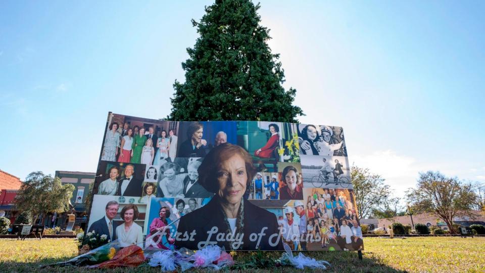 PHOTO: A memorial and flowers for Rosalynn Carter have been placed in front of the Christmas tree, Nov. 25, 2023, in Plains, Ga.  (Alex Brandon/AP)