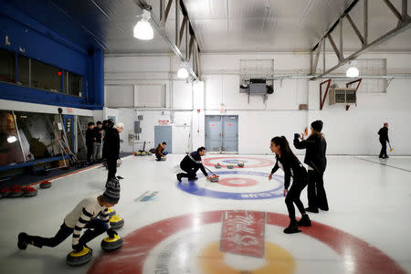 Refugees take to the ice as they are introduced to the sport of curling at the Royal Canadian Curling Club during an event put on by the "Together Project", in Toronto, March 15, 2017. REUTERS/Mark Blinch