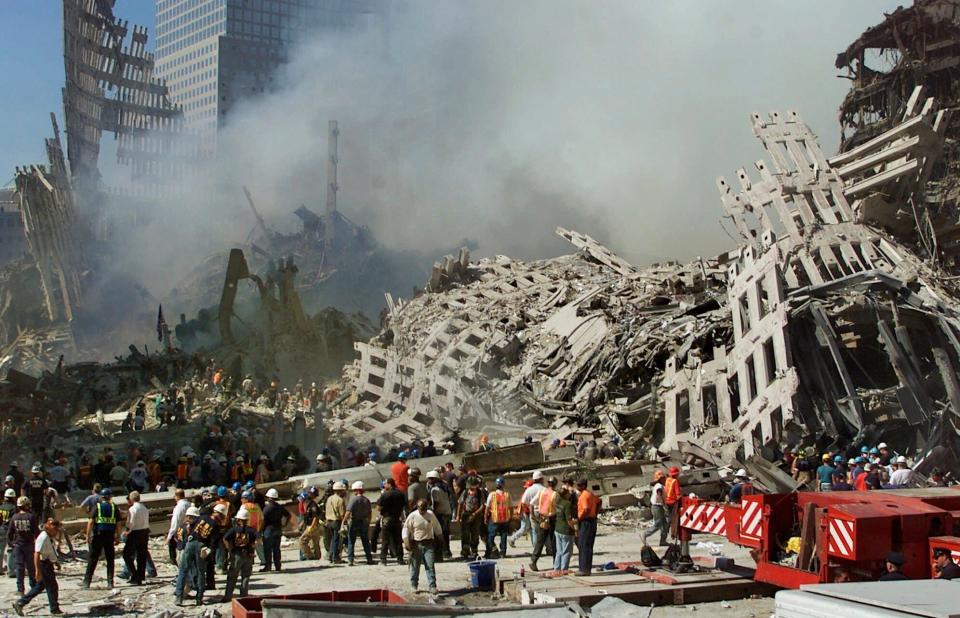 Rescue workers continue their search as smoke rises from the rubble of the World Trade Center after the Sept. 11, 2001, terrorist attacks.