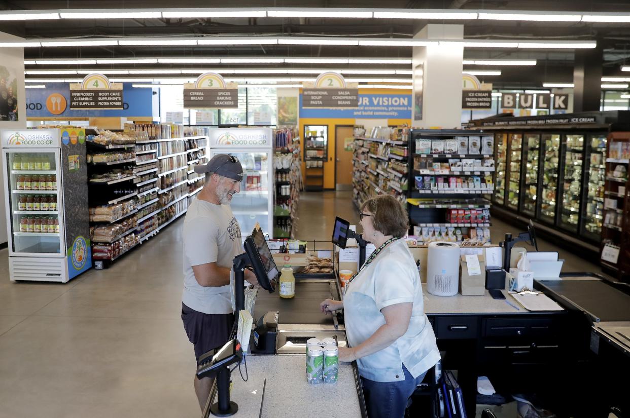 Cashier Ellen Harwell helps customer Travis Sullivan July 12, 2022, at the Oshkosh Food Co-op, 155 Jackson St. The co-op marked one  year on July 22.