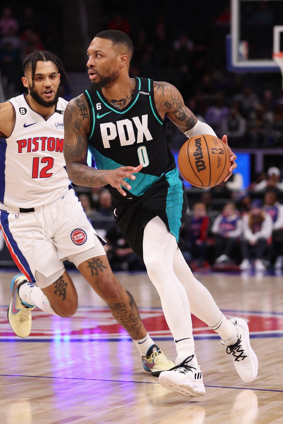 Trail Blazers guard Damian Lillard drives around Pistons forward Isaiah Livers during the first half on Monday, March 6, 2023, at Little Caesars Arena.