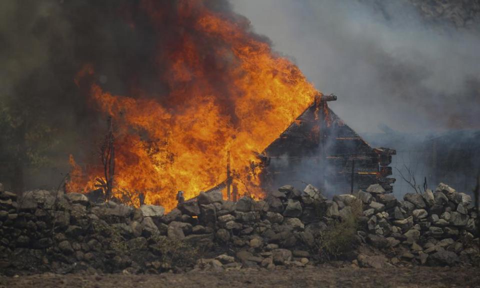 A fire engulfs a house in the village of Cokertme, near Bodrum, in Mugla province, Turkey