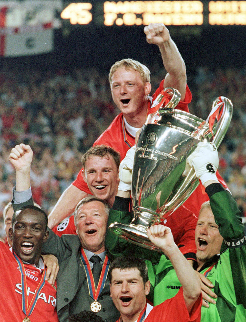 FILE - In this Wednesday, May 26, 1999 file photo Manchester United manager Alex Ferguson, 2nd left, celebrates with his players after they won the Champions League final soccer match at the Nou Camp Stadium in Barcelona, Spain. C is for Comeback. Manchester United's 2-1 win in the 1999 final when they scored two goals in injury time to clinch the trophy after trailing since early in the match is still considered one of the greatest comebacks in the tournament's history. (AP Photo/Cesar Rangel, File)