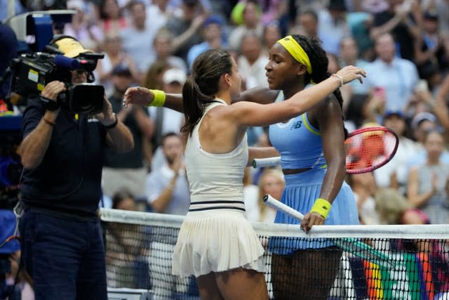 Emma Navarro, left, and Coco Gauff hug at the net 