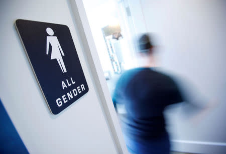 FILE PHOTO - A bathroom sign welcomes both genders at the Cacao Cinnamon coffee shop in Durham, North Carolina, United States on May 3, 2016. REUTERS/Jonathan Drake/File Photo