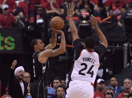 May 25, 2019; Toronto, Ontario, CAN; Milwaukee Bucks guard George Hill (3) shoots for a basket past Toronto Raptors guard Norman Powell (24) in the first half of game six of the Eastern Conference final at Scotiabank Arena. Dan Hamilton-USA TODAY Sports