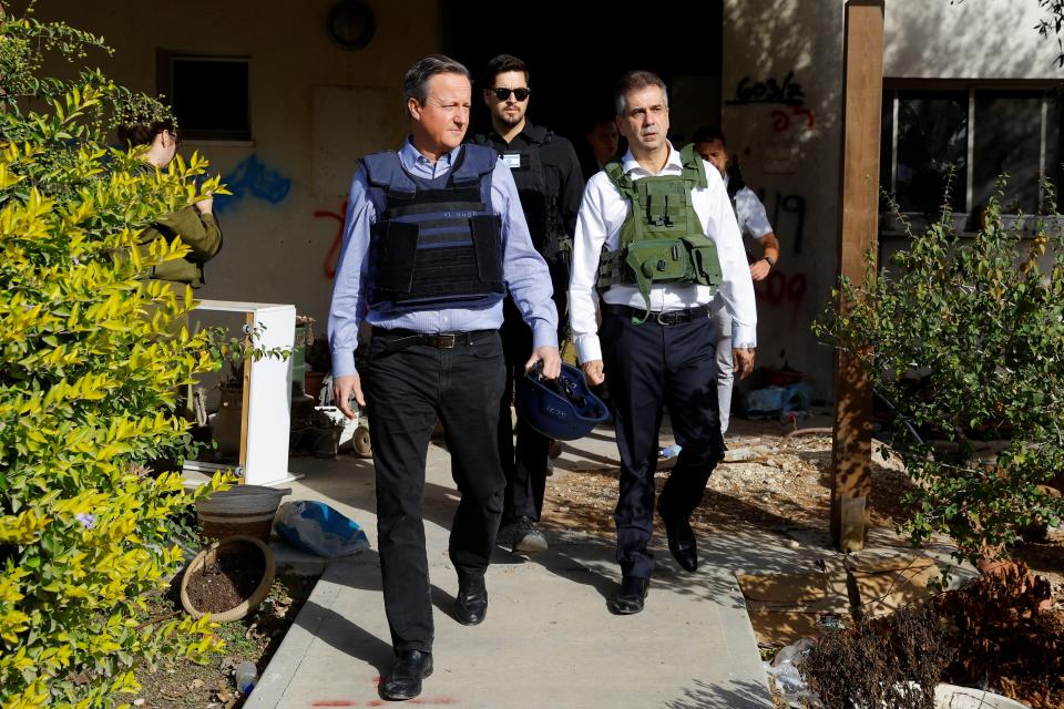 British foreign secretary David Cameron and Israeli foreign minister Eli Cohen visit Kibbutz Beeri following the 7 October deadly attack by the Palestinian Islamist group Hamas (Reuters)