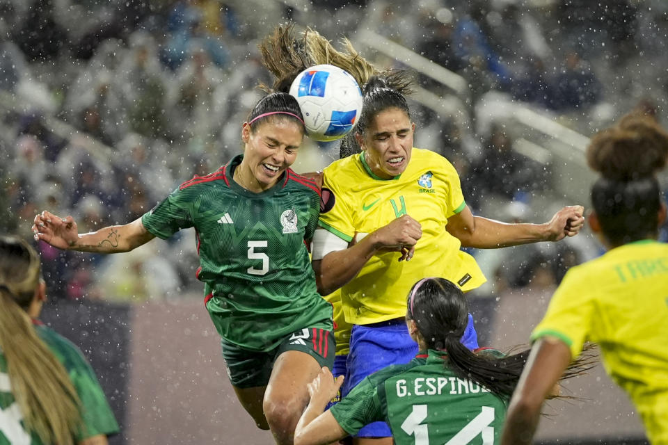 Mexico's Karen Luna (5) and Brazil's Rafaelle (4) battle for a header off a corner kick during the second half of a CONCACAF Gold Cup women's soccer tournament semifinal match, Wednesday, March 6, 2024, in San Diego. (AP Photo/Gregory Bull)