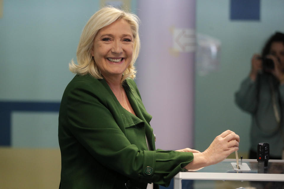 French far-right leader Marine Le Pen casts her ballot for the first round of the parliamentary elections, Sunday, June 12, 2022 in Henin-Beaumont, northern France. French voters are choosing lawmakers in a parliamentary election as President Emmanuel Macron seeks to secure his majority while under growing threat from a leftist coalition. (AP Photo/Michel Spingler)