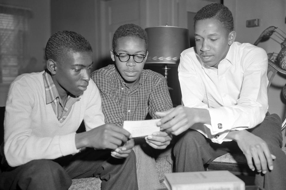 FILE - Three African-American undergraduate students, from left, John Lewis Brandon, and brothers Leroy and Ralph Frasier, who were admitted to the University of North Carolina, check their grades between semesters at their home in Durham, N.C. on Feb. 8, 1956. Ralph Frasier, the final surviving member of a trio of African American youths who were the first to desegregate the undergraduate student body at North Carolina's flagship public university in the 1950s, died May 8, 2024, at age 85 at the Mayo Clinic in Jacksonville, Fla., according to son Ralph Frasier Jr.(AP Photo/Rudolph Faircloth, File)