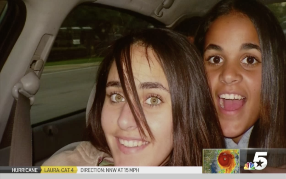 Amina and Sarah are seen hugging in a car.