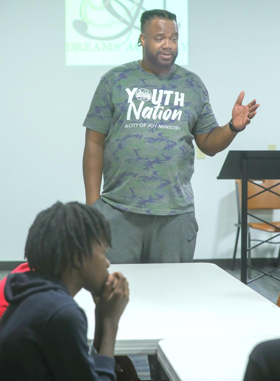 Andre Hampton, program manager of Dreams Academy, talks with participants during a meeting at The House of the Lord on June 26 in Akron.