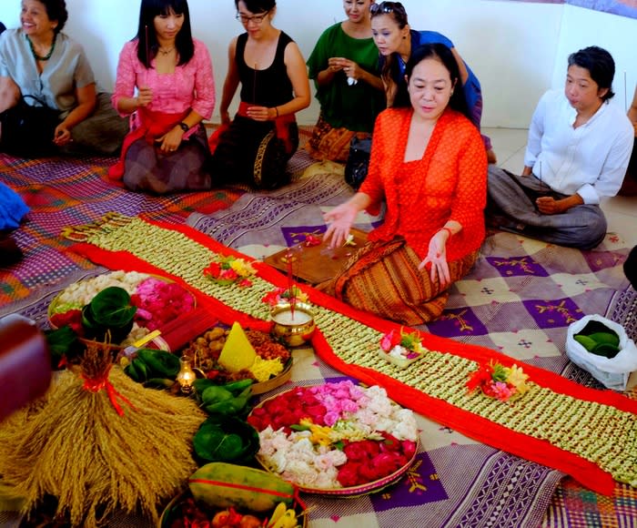 Offering: Josephine "Obin" Komara explains the meaning of a set of offerings to guests during the opening of the Museum Kain on Wednesday. (