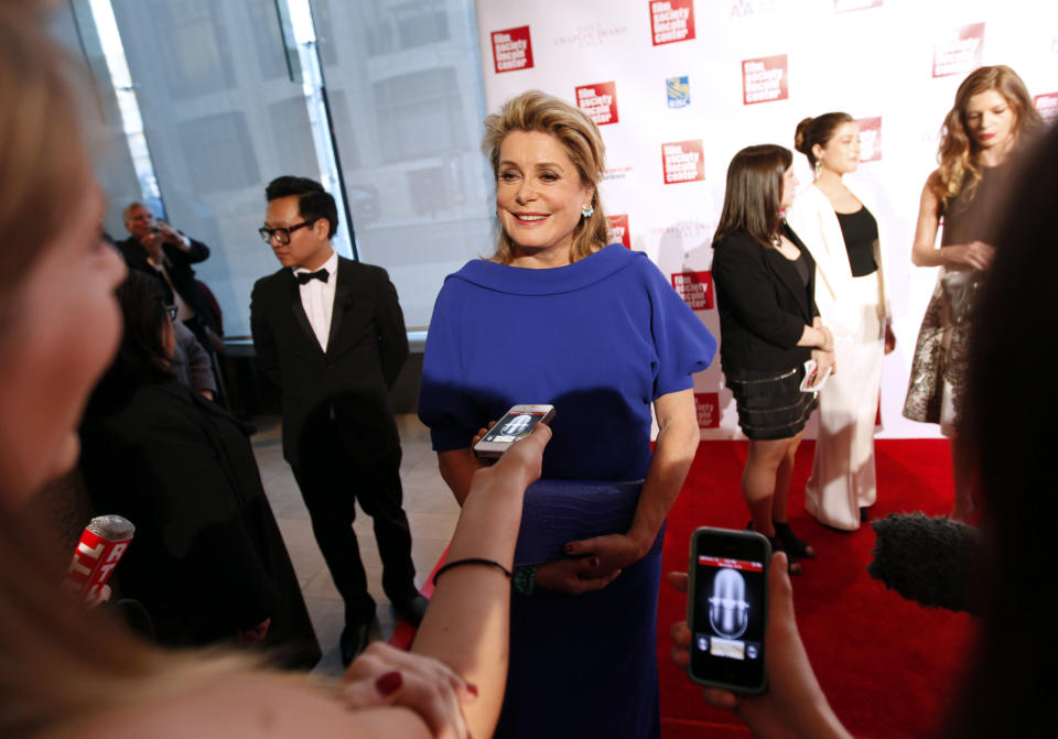 French actress Catherine Deneuve is interviewed as she arrives for the Film Society of Lincoln Center's 39th annual Chaplin Award Gala at Alice Tully Hall, Monday, April 2, 2012 in New York. (AP Photo/Jason DeCrow)