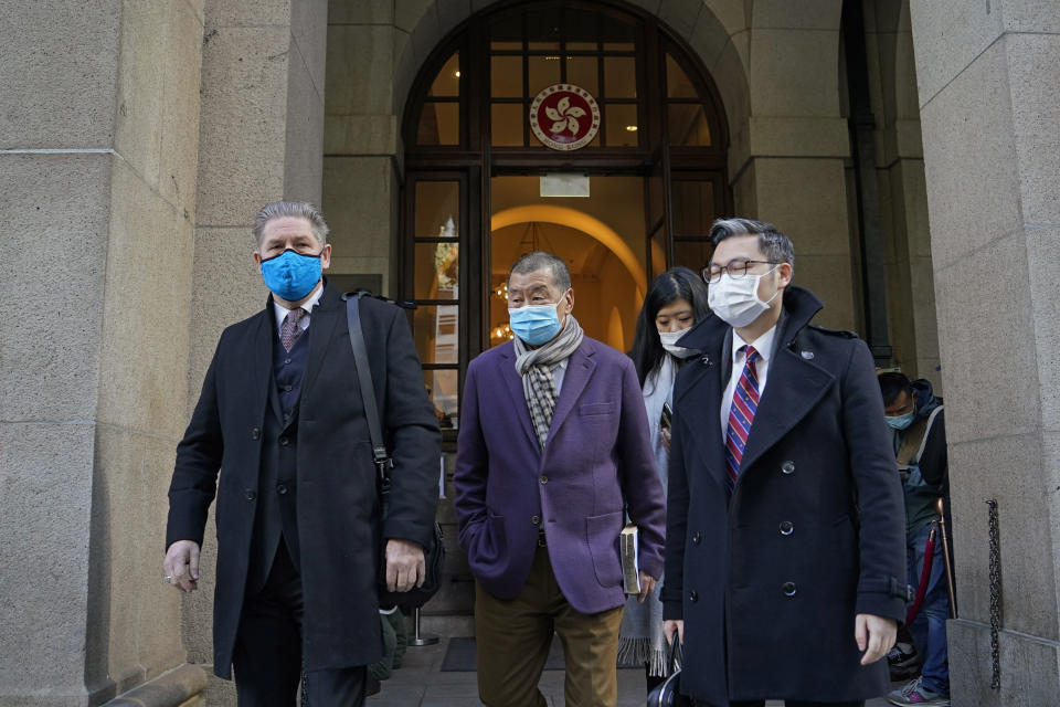 Hong Kong pro-democracy activist and media tycoon Jimmy Lai, center, leaves the Court of Final Appeal during a break in Hong Kong, Thursday, Dec. 31, 2020. Lai appeared in court Thursday as prosecutors asked the city's top judges to send him back to detention after he was granted bail last week on fraud and national security-related charges. (AP Photo/Kin Cheung)