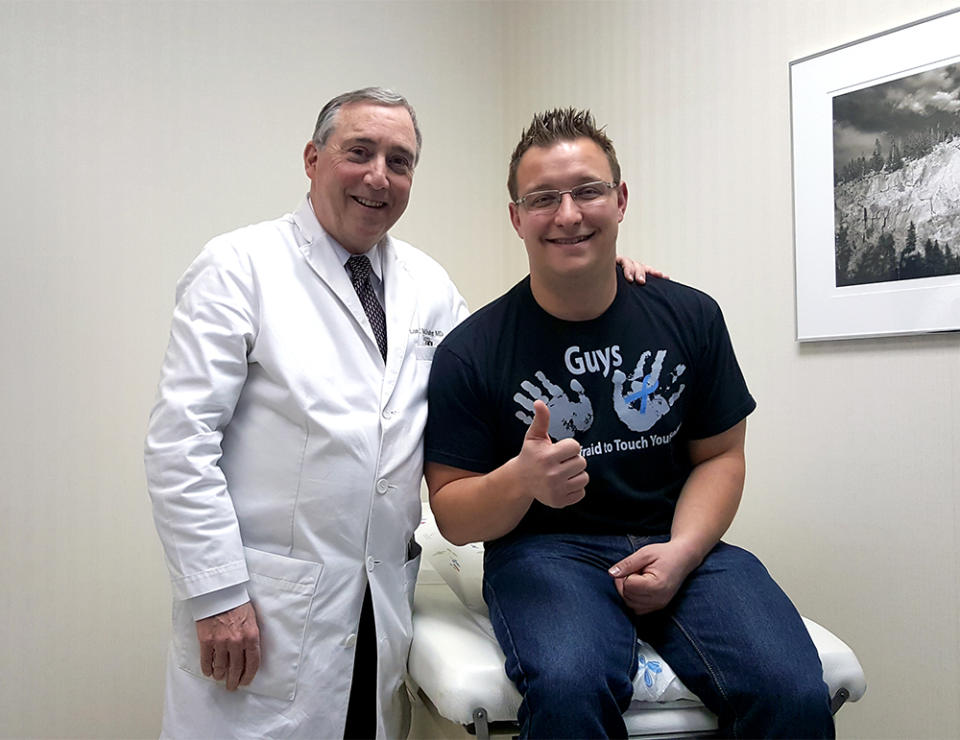 Bret Miller with his surgeon. Miller is wearing the T-shirt his brother created for the Male Breast Cancer Coalition. (Photo courtesy of Bret Miller)