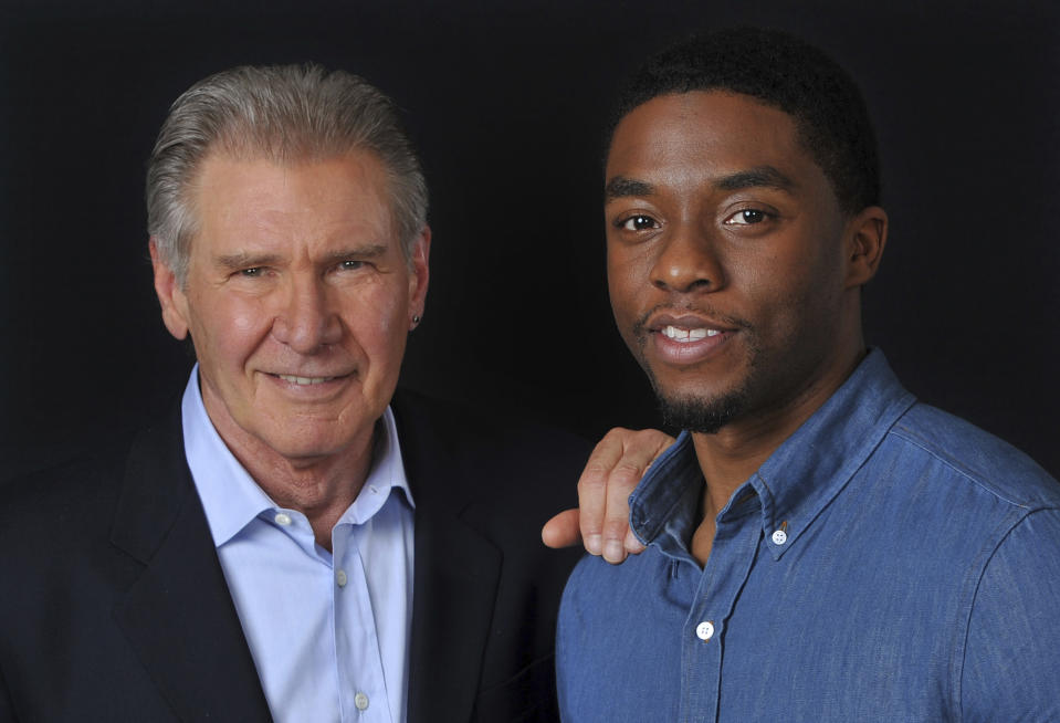 In this Saturday, March 23, 2013 file photo, Harrison Ford, left, and Chadwick Boseman, cast members in the film "42," pose together for a portrait, in Los Angeles. Boseman, who played Black icons Jackie Robinson and James Brown before finding fame as the regal Black Panther in the Marvel cinematic universe, has died of cancer. His representative says Boseman died Friday, Aug. 28, 2020 in Los Angeles after a four-year battle with colon cancer. He was 43. (Photo by Chris Pizzello/Invision/AP, File)