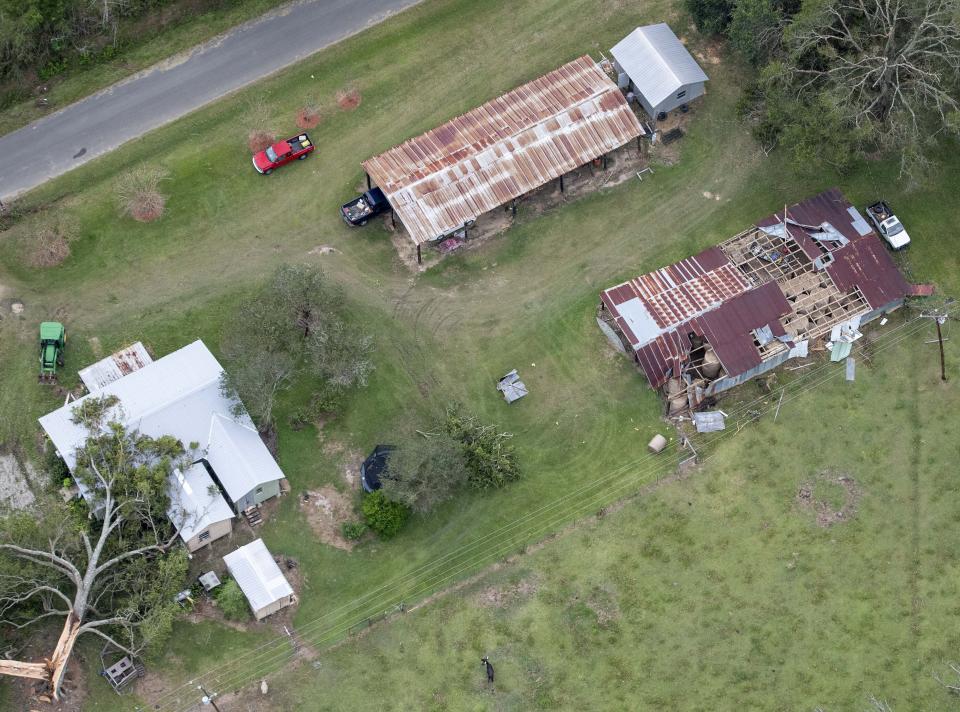 Fallen trees and damaged roofs are left in the aftermath of Hurricane Laura, Friday, Aug. 28, 2020, near DeRidder, La., as seen during Gov. John Bel Edwards' aerial tour of stricken areas in the northern part of the state. (Bill Feig/The Advocate via AP, Pool)