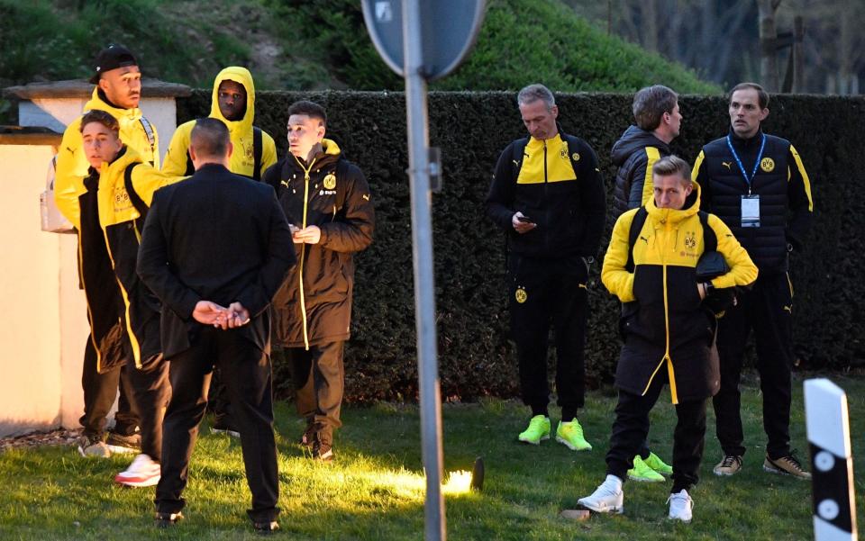 Head coach Thomas Tuchel, right, and players of Borussia Dortmund stand outside their team bus after it was damaged - Credit: Martin Meissner/AP