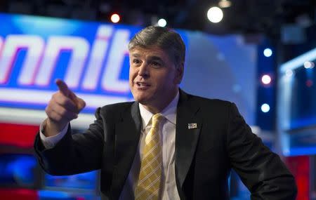 Fox News Channel anchor Sean Hannity poses for photographs as he sits on the set of his show "Hannity" at the Fox News Channel's studios in New York City, October 28, 2014. REUTERS/Mike Segar
