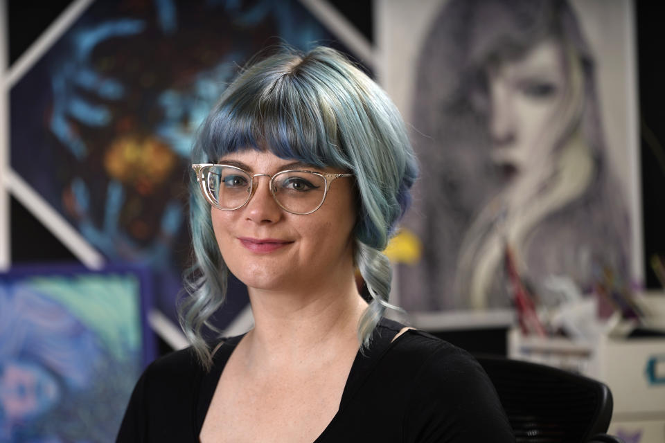 Kelly McKernan poses for a portrait Tuesday, Aug. 15, 2023, in Nashville, Tenn. McKernan is an artist and one of three plaintiffs in a lawsuit against Artificial Intelligence companies they allege have infringed on their copyright. (AP Photo/George Walker IV)