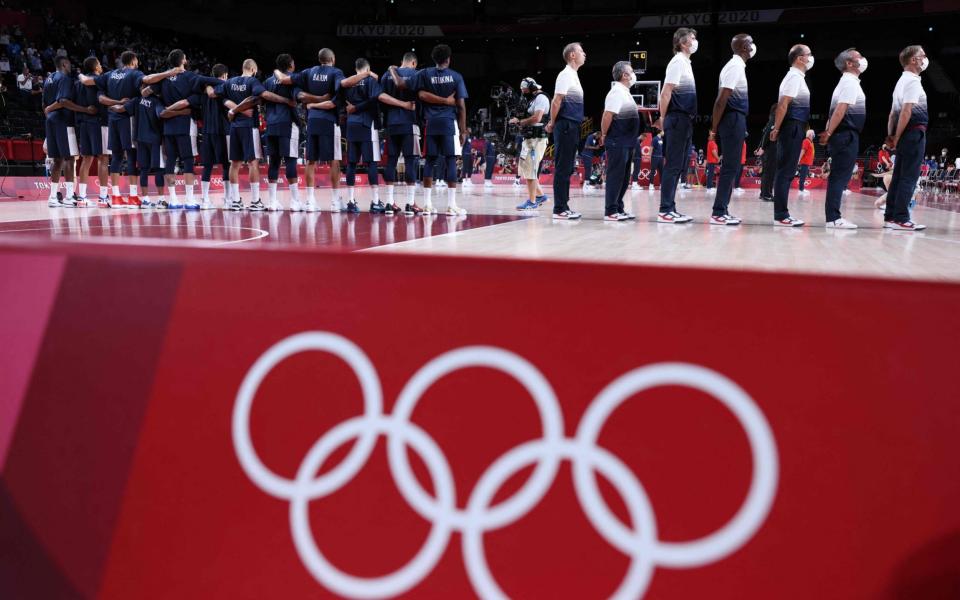 French team members stand in respect for the national anthem before the start of the men's final basketball match between France and USA during the Tokyo 2020 Olympic Games at the Saitama Super Arena in Saitama on August 7, 2021. - Thomas COEX / AFP via Getty Images