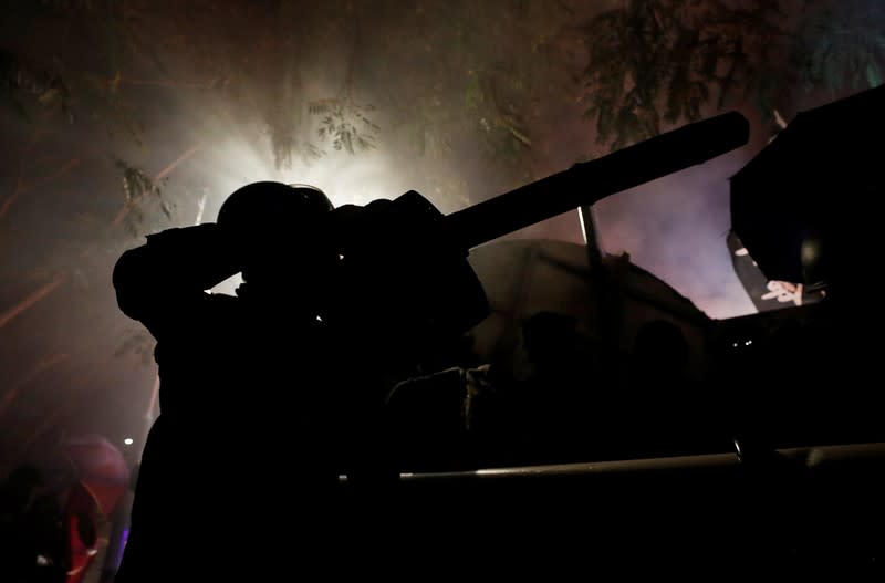 A protester uses a snowblower during a standoff with riot police at the Chinese University of Hong Kong