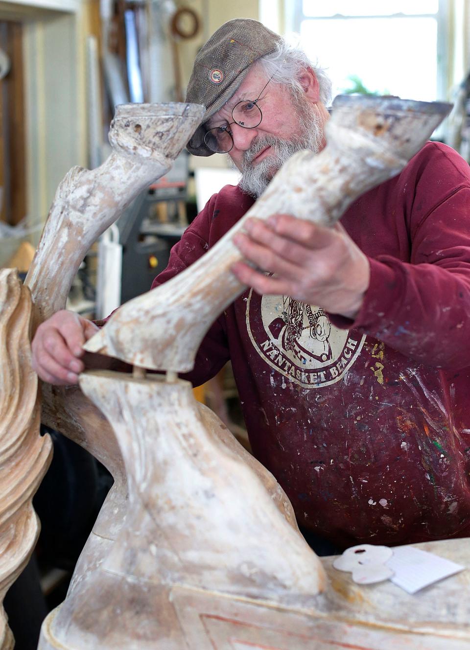 Restoration artist James Hardison of the Friends of the Paragon Carousel works on one of the 66 bass wood horses of the carousel on Tuesday, March 16, 2021. The horses were made in 1928 by the Philadelphia Toboggan Co. Hardison has restored 50 of the 66 horses over the last decade plus.