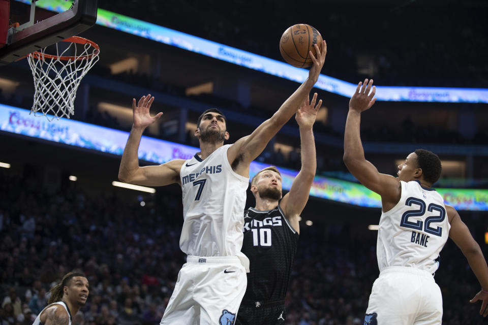 Memphis Grizzlies forward Santi Aldama (7) rebounds a ball in front of Sacramento Kings forward Domantas Sabonis (10) and Grizzlies guard Desmond Bane (22) in the first quarter of an NBA basketball game in Sacramento, Calif., Thursday, Oct. 27, 2022. (AP Photo/José Luis Villegas)