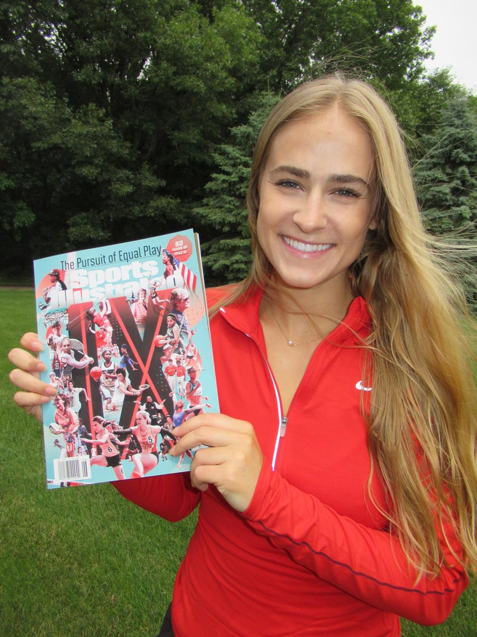 Allyson Faulkner holding the June 2022 Sports Illustrated Magazine Cover featuring her photo