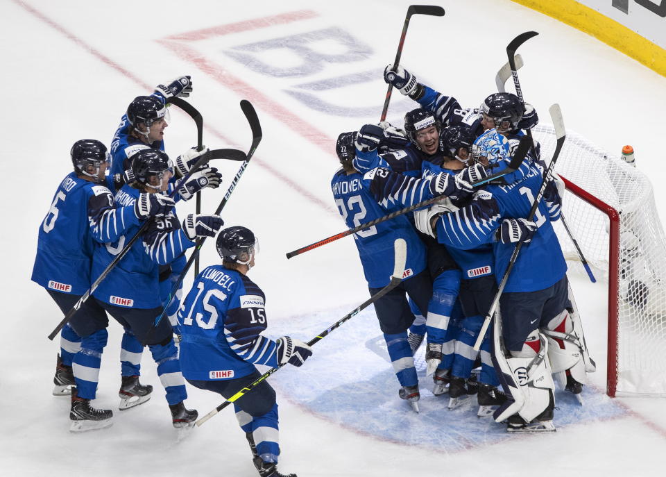 Finland celebrates the win over Sweden after an IIHL World Junior Hockey Championship game, Saturday, Jan. 2, 2021 in Edmonton, Alberta. (Jason Franson/The Canadian Press via AP)