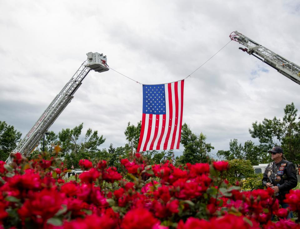 A U.S. flag is displayed between to fire engines during the Fallen Firefighters Memorial Ceremony on Thursday, June 9, 2022 in Salem, Ore. 