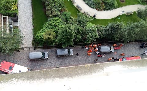 Officials and rescuers gather near vehicles after a car slammed into soldiers on patrol in Levallois-Perret - Credit: THIERRY CHAPPE/AFP/Getty Images