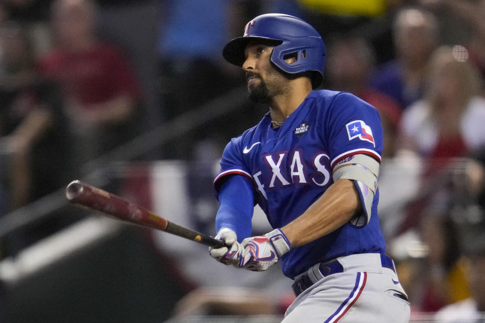 Texas Rangers' Marcus Semien watches his two-run home run against the Arizona Diamondbacks during the ninth inning in Game 5 of the baseball World Series Wednesday, Nov. 1, 2023, in Phoenix. (AP Photo/Godofredo A. Vásquez)