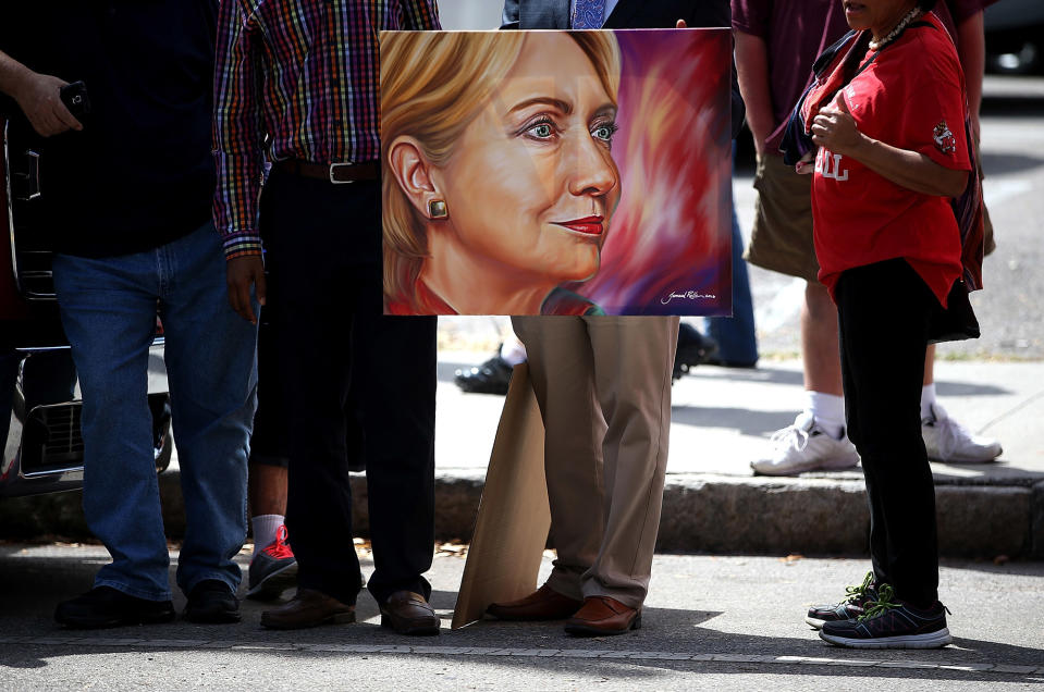 <p>Supporters of Hillary Clinton hold a painting outside of a rally in Tampa, Fla., March 10, 2016. (Justin Sullivan/Getty Images) </p>