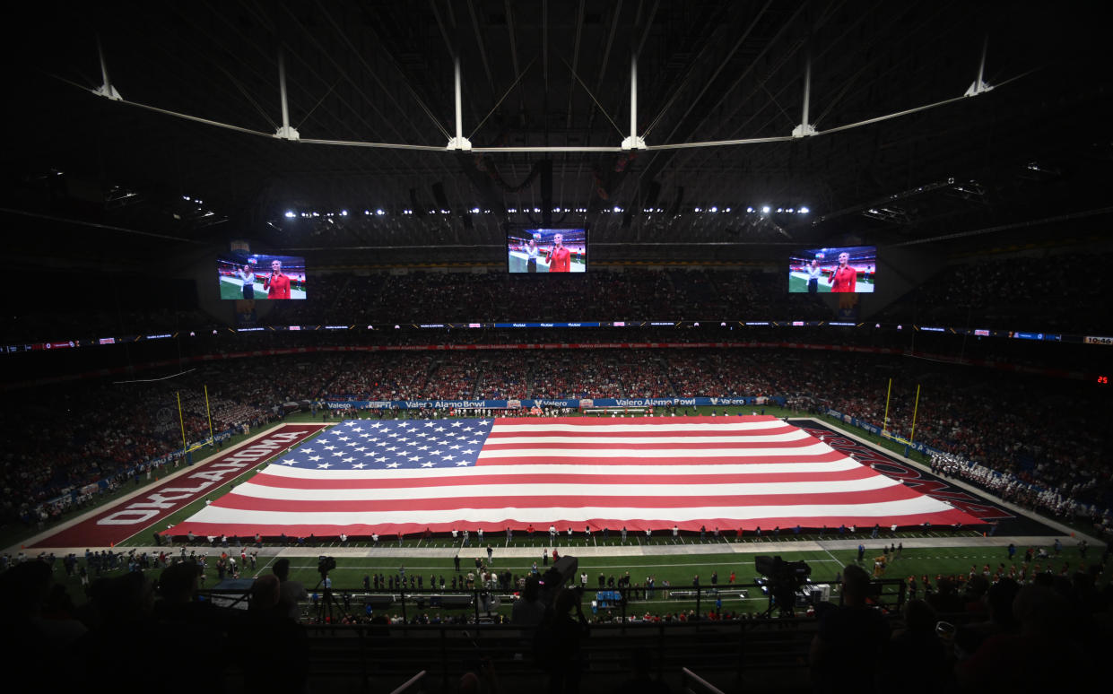 SAN ANTONIO, TX - DECEMBER 28: A giant USA flag is displayed during the national anthem prior to start of Valero Alamo Bowl game featuring the Arizona Wildcats and the Oklahoma Sooners on December 28, 2023 at the Alamodome in San Antonio, TX. (Photo by John Rivera/Icon Sportswire via Getty Images)