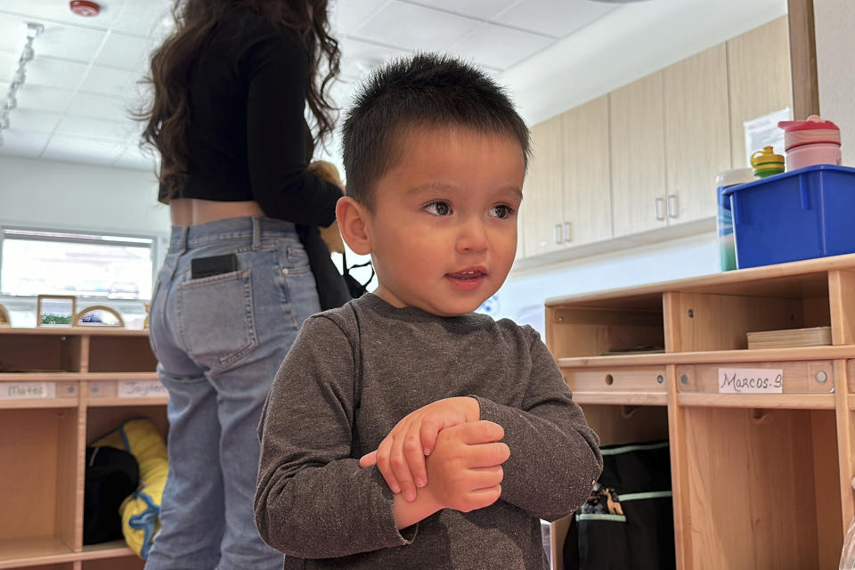 Mateo Arambula waits for his mother, Marisshia Sigala, to collect his things as she picks him up from Koala Children's Academy after a day of work in Albuquerque, New Mexico, on Wednesday, March 20, 2024. Like most other New Mexico families, Sigala and her husband qualify for subsidized child care in New Mexico, providing them more flexibility to see more clients as they build their careers. (AP Photo/Susan Montoya Bryan)