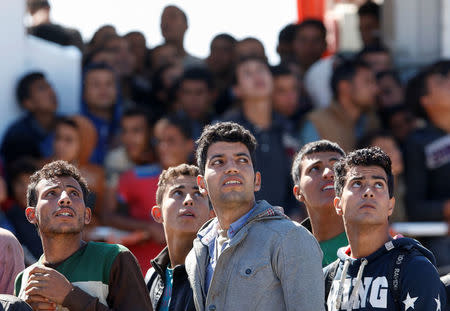 Migrants disembark from the Italian coastguard vessel Peluso in the Sicilian harbour of Augusta, Italy, May 13, 2016. REUTERS/Antonio Parrinello