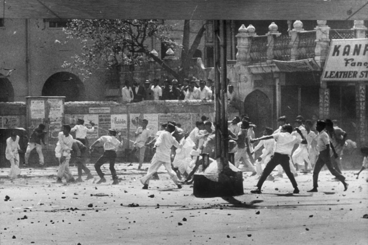 Stone-throwing by a mob in Old Delhi during riots between Hindus and Sikhs over the future of Punjab state in 1966. 