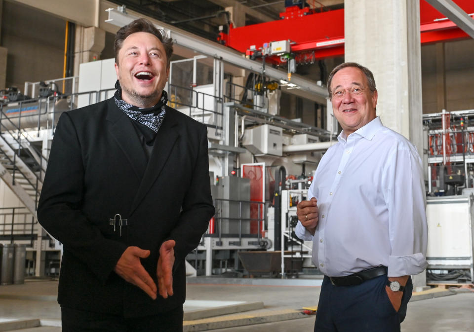 Tesla CEO Elon Musk and Armin Laschet, CDU Federal Chairman and Prime Minister of North Rhine-Westphalia, talk during a tour of the plant of the future foundry of the Tesla Gigafactory on August 13, 2021 in Grünheide near Berlin, Germany. (Credit: Patrick Pleul/Getty Images)