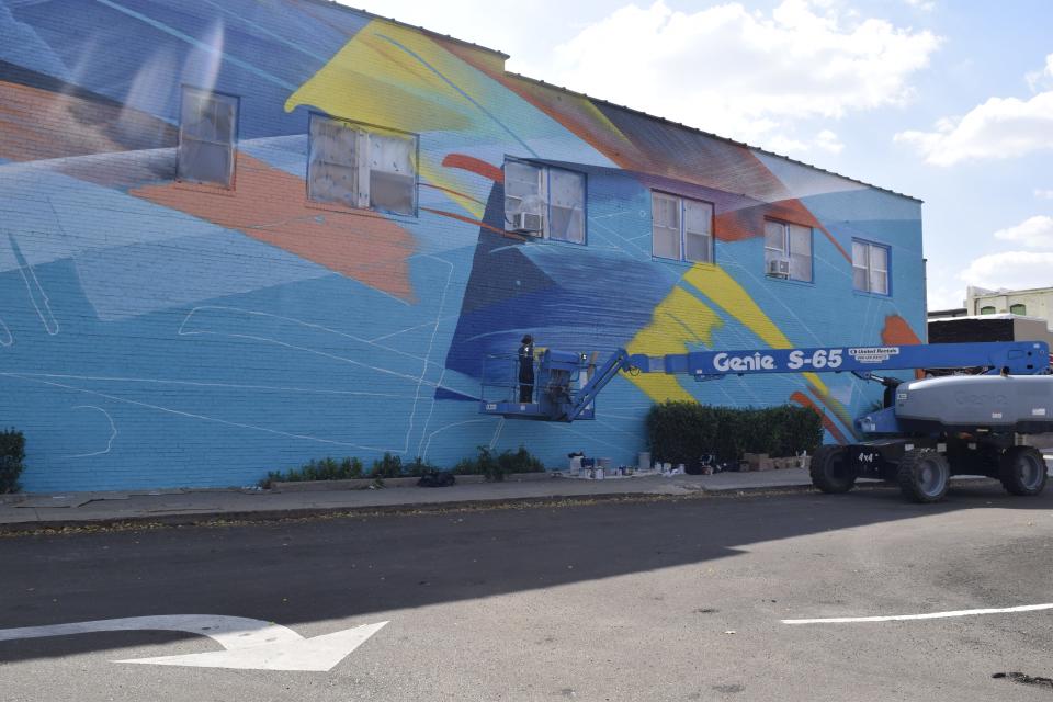 MadC, an artist from Germany, works on her contribution to the 2023 Boom! Salina Street Art and Mural Festival in the parking lot east of Campbell Plaza. Eight total murals are currently being created throughout downtown Salina as part of the festival.