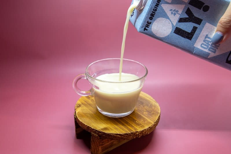 pouring shot of oatly