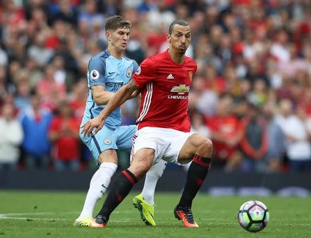 Britain Soccer Football - Manchester United v Manchester City - Premier League - Old Trafford - 10/9/16 Manchester United's Zlatan Ibrahimovic in action with Manchester City's John Stones Reuters / Phil Noble/ Livepic