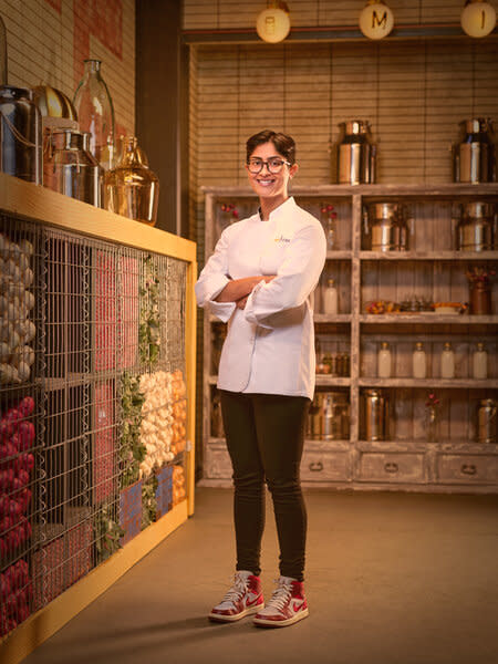 Full length of Rasika Venkatesa in her chef's uniform in a kitchen pantry