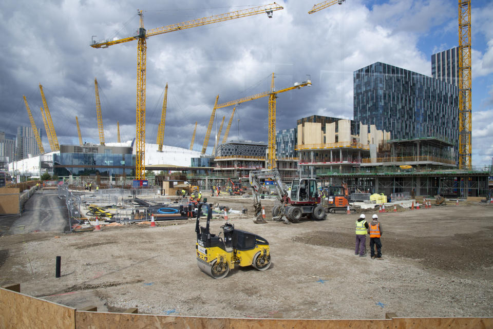 Yellow cranes blend with yellow girders of the O2 arena as on going construction work continues at the Design District site in Greenwich Peninsula in London, United Kingdom on 15th August , 2019. Scheduled to fully open in 2020, developers Knight Dragon Developments Ltd aim to deliver 15,000 new homes. 13,000 new jobs. 7 new neighbourhoods.(photo by Claire Doherty/In Pictures via Getty Images)
